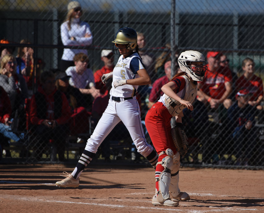 Legacy's Kendall Aragon, left, scores the tying run against Heritage in a CHSAA 5A regional round playoff game in Broomfield Oct. 16. The Lightning beat Heritage, 8-7 and Cherokee Trail, 7-2 to advance to the state tournament later this week.